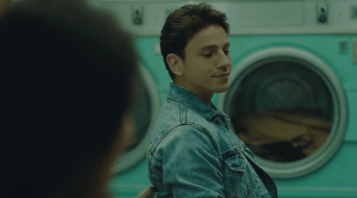 a man standing in front of a washing machine