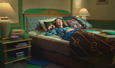 a woman laying on top of a bed in a bedroom