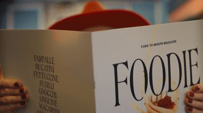 a person reading a book about foodie