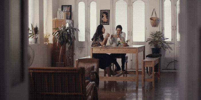 a couple of women sitting at a table in a room