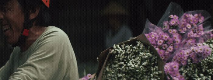 a man holding a bunch of flowers in his hands