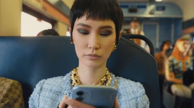 a woman on a train looking at her cell phone