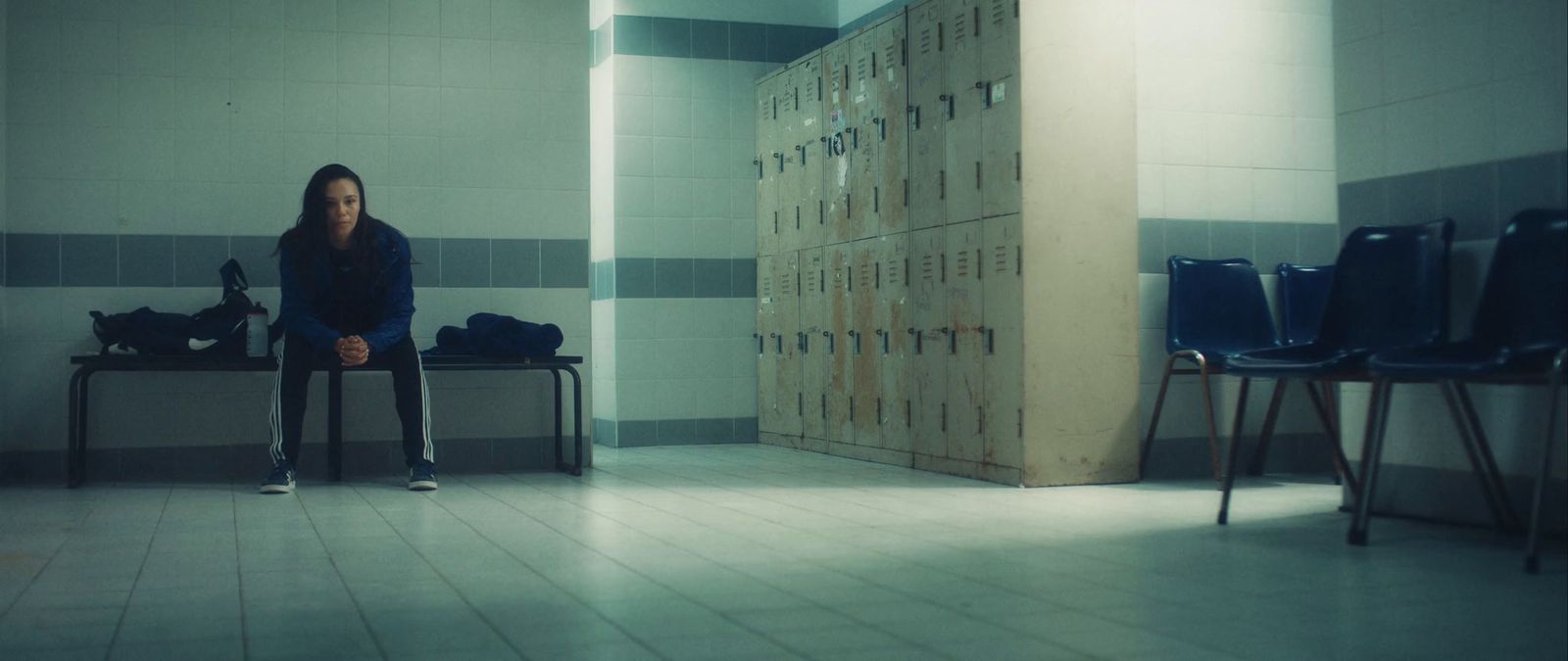 a woman sitting on a bench in a room