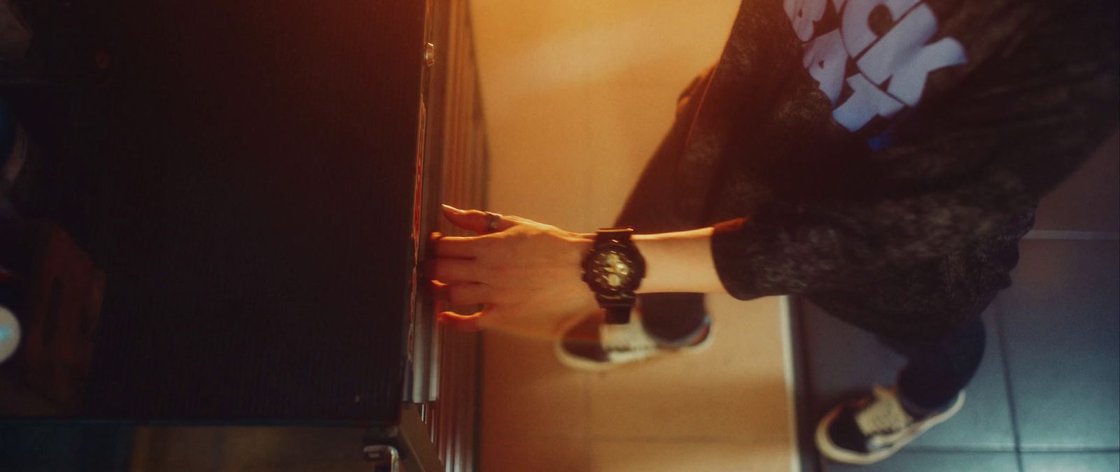 a person standing in front of a mirror holding a watch