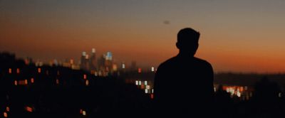 a man standing in front of a city skyline