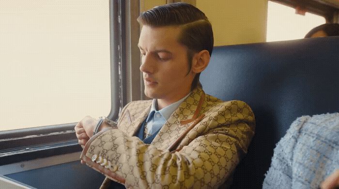 a man in a suit sitting on a train