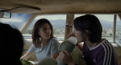 two women sitting in a car talking to each other