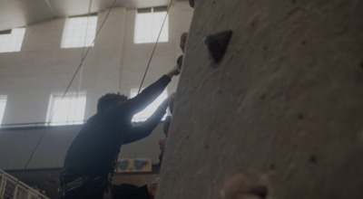 a man climbing up the side of a rock wall