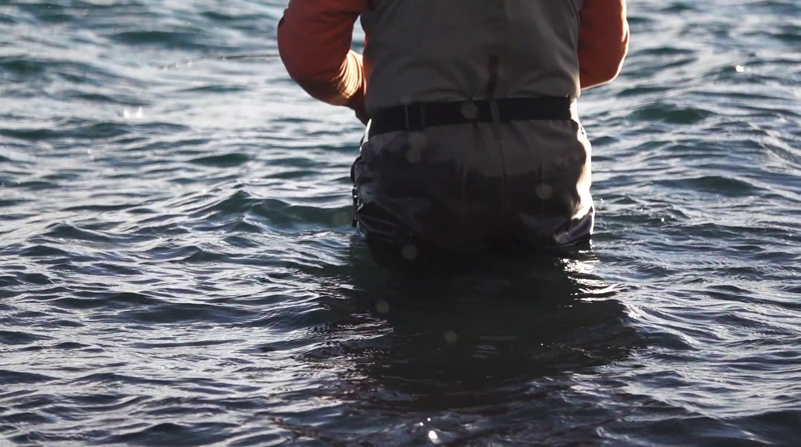 a man standing in a body of water