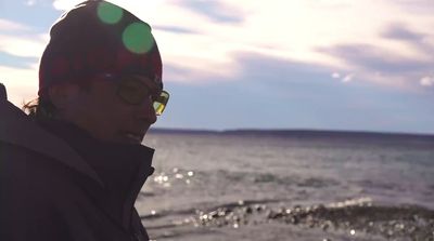 a man wearing sunglasses and a hat on a boat