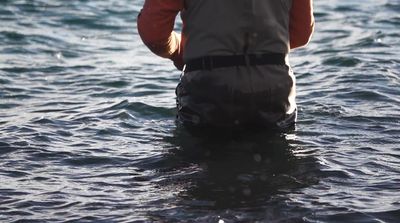 a man standing in a body of water