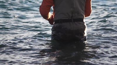 a man standing in a body of water