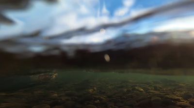 a blurry photo of rocks and water under a cloudy sky