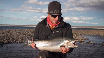 a man holding a fish in his hands