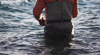 a man standing in a body of water