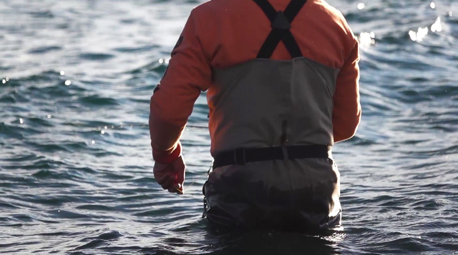 a man standing in a body of water