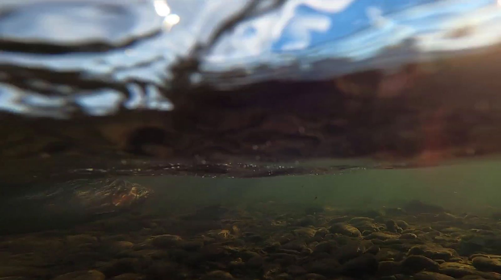 an underwater view of rocks and water