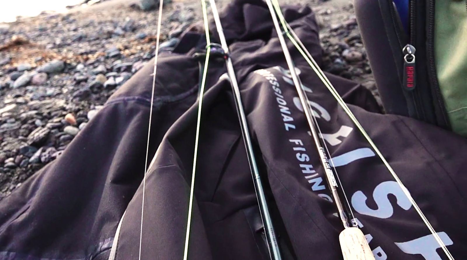 a close up of a fishing pole on a rocky beach