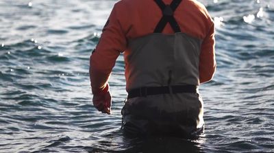 a man standing in a body of water