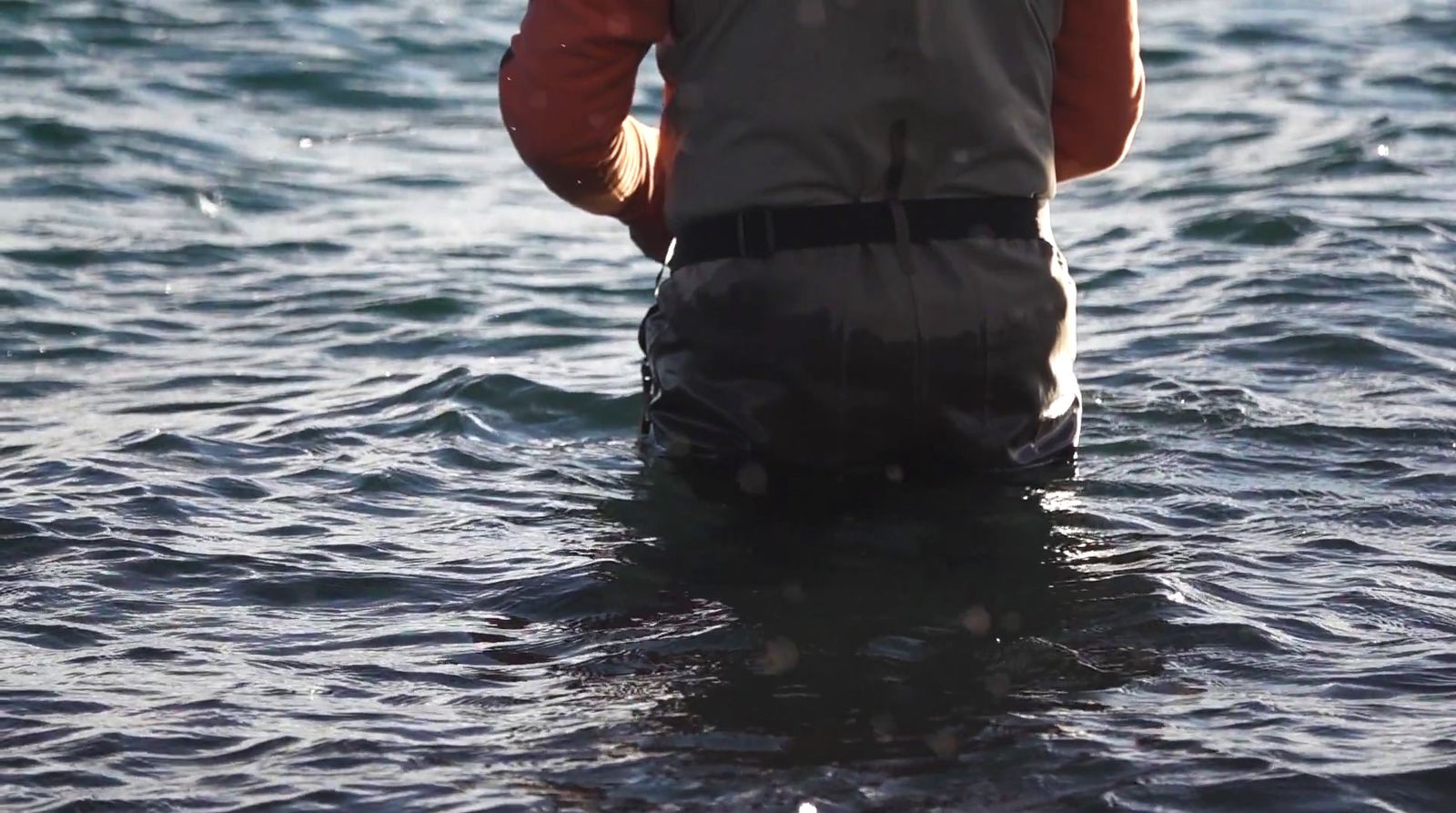 a man standing in a body of water