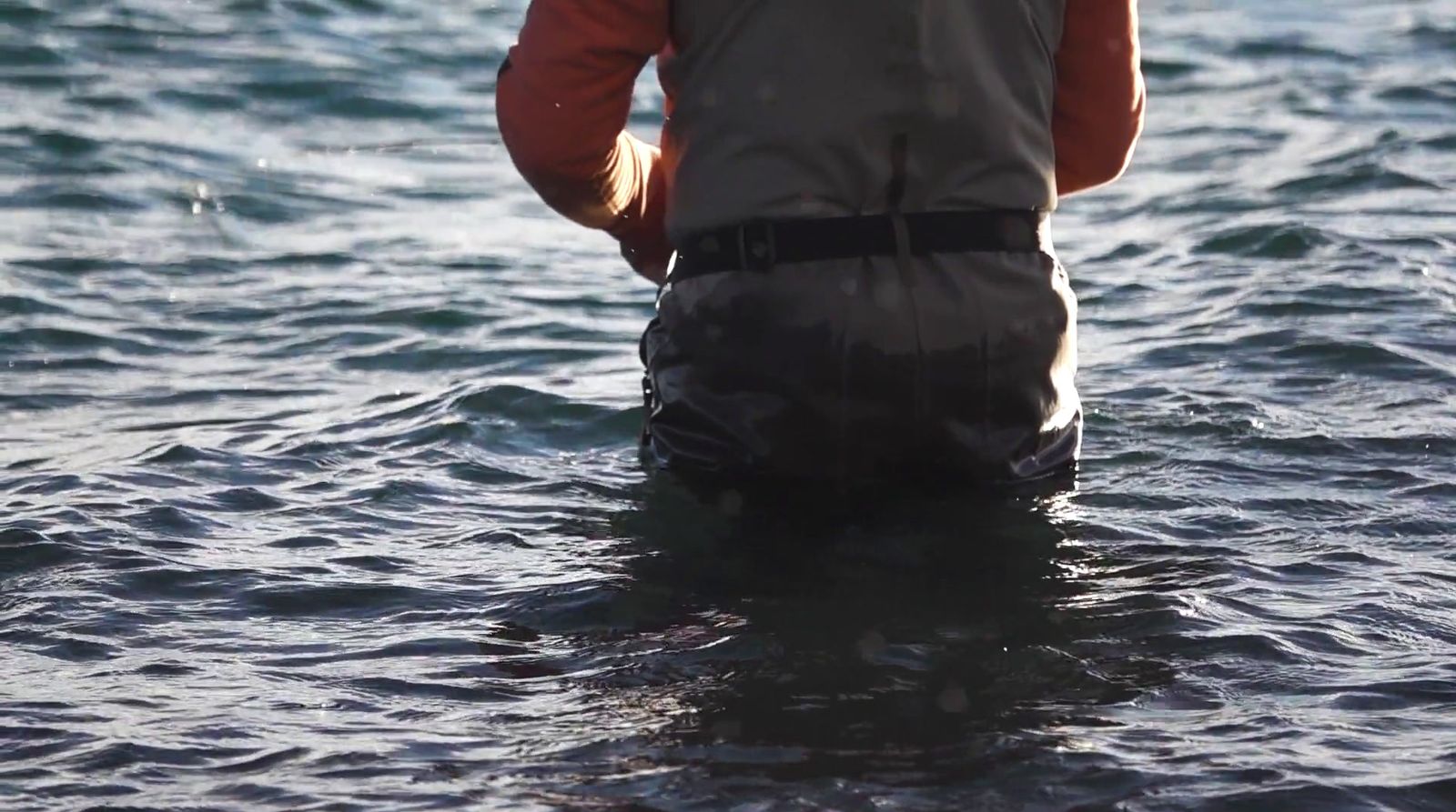 a man standing in a body of water