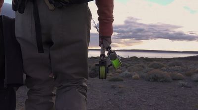 a man holding a fishing rod and a reel