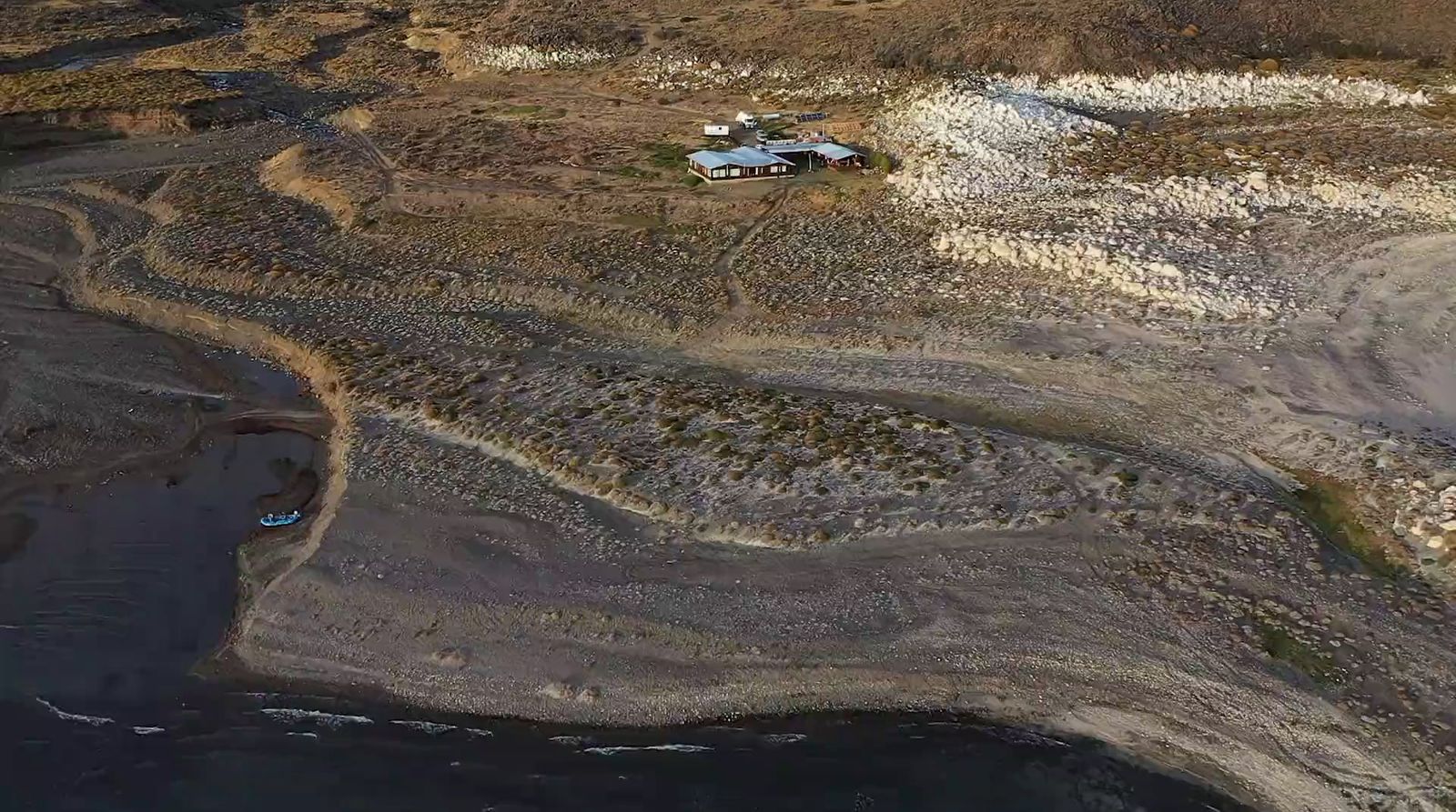 an aerial view of a house on a beach