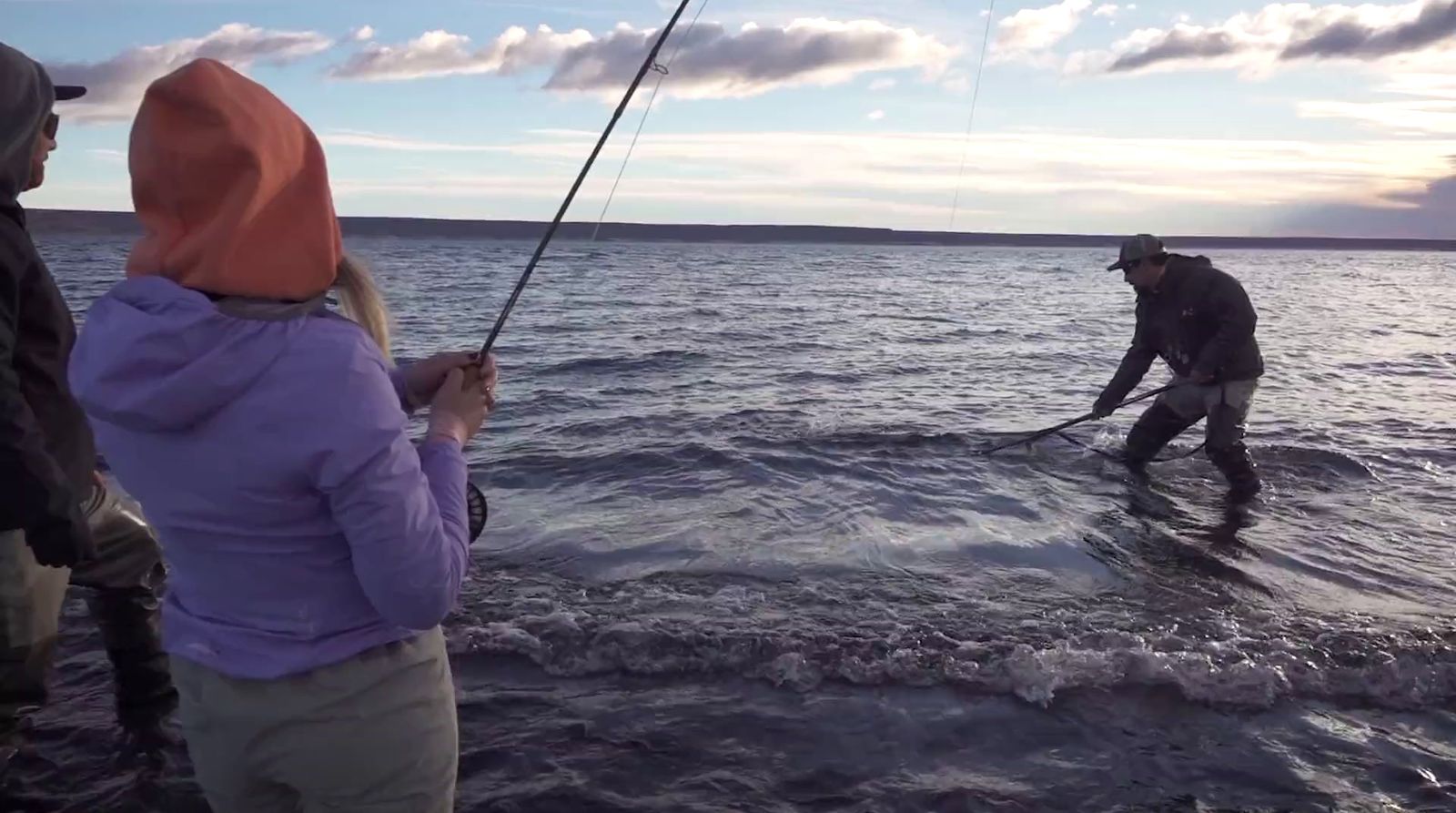 a man and a woman fishing in the ocean