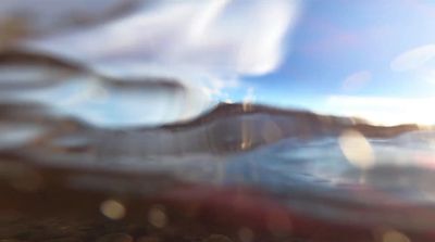 a blurry photo of a beach and water