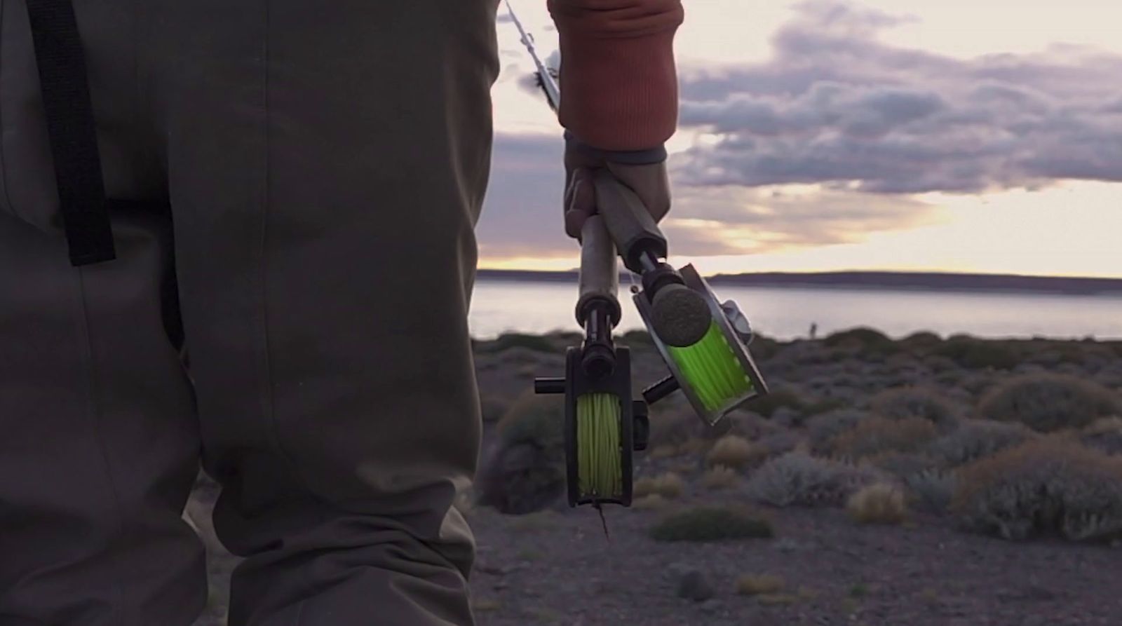 a man holding a fishing rod and a reel