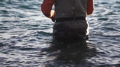 a man standing in a body of water