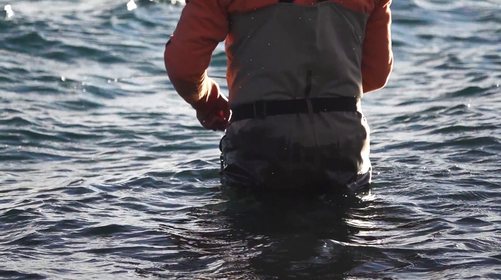 a man standing in a body of water