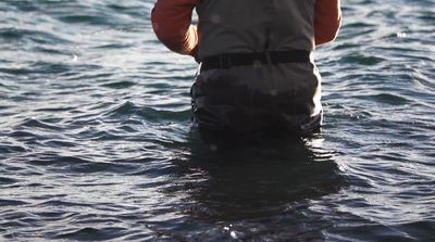 a man standing in a body of water