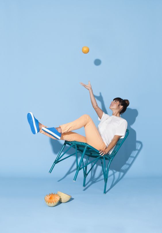 a woman is sitting in a chair with a tennis racket