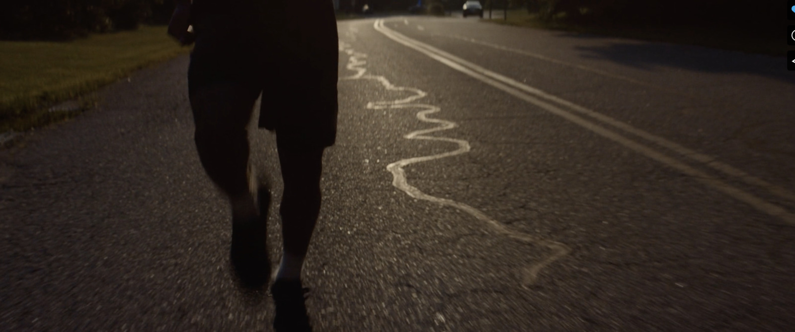 a person walking down a street at night