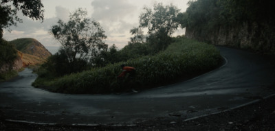 a person riding a bike down a winding road