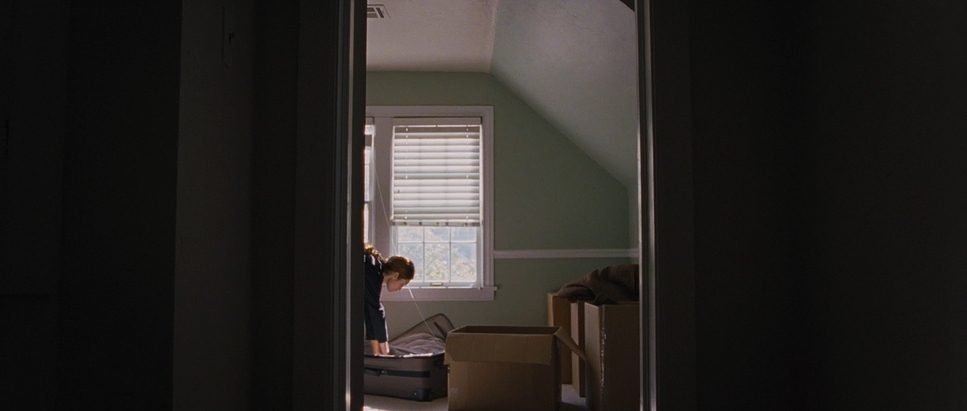 a woman standing in a room next to a window