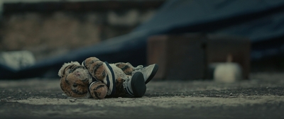 a teddy bear is laying on the ground