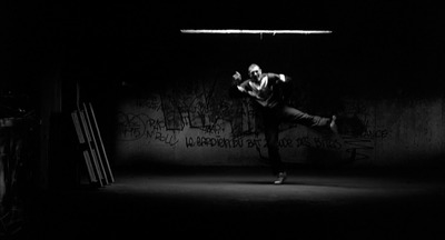 a man is dancing in a dark room