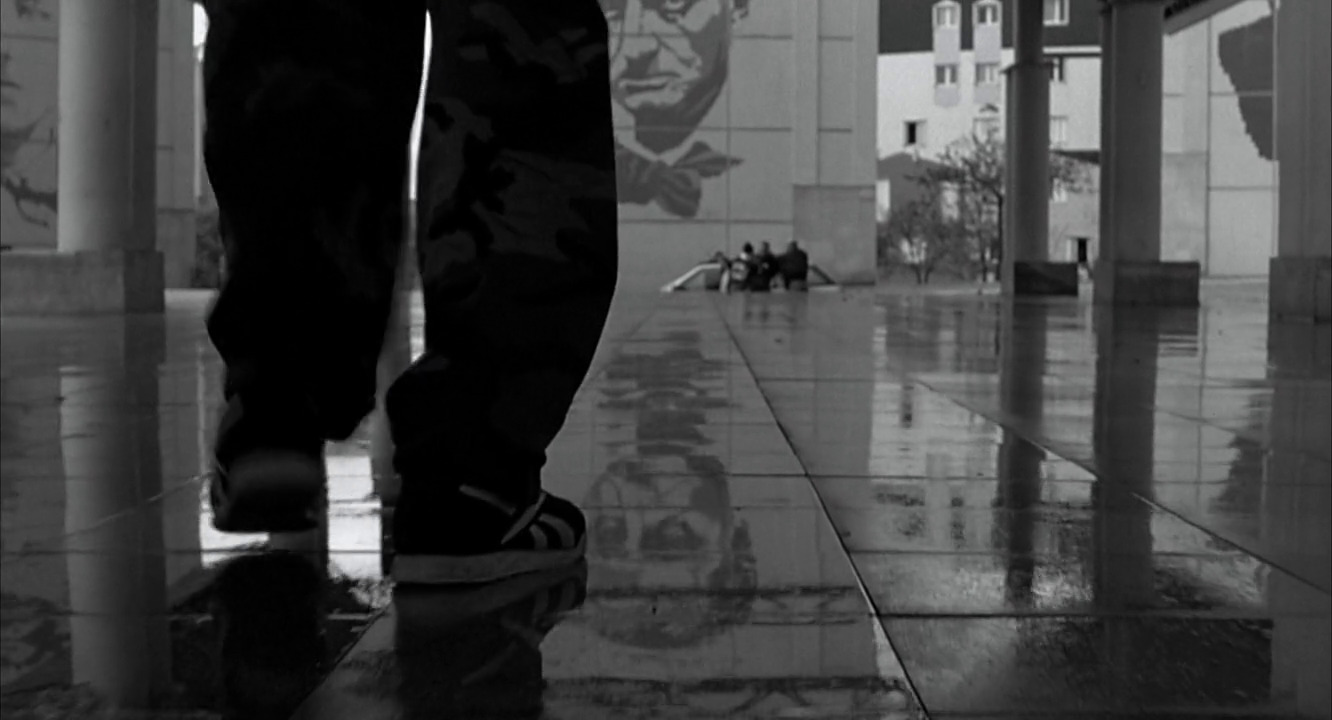 a black and white photo of a person standing in a hallway