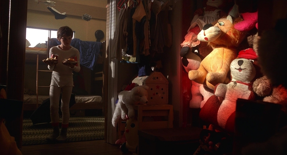 a person standing in a room with stuffed animals