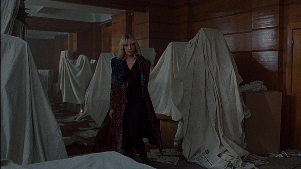 a woman standing in a room full of white sheets