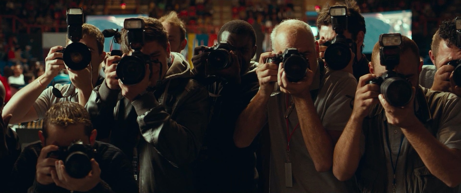 a group of people taking pictures with their cameras