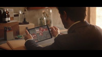 a man is playing a game on a tablet