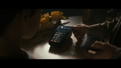 a person holding a remote control on a table