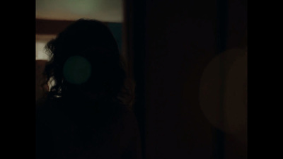 a blurry image of a woman's head in the dark