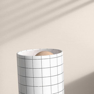 a white vase sitting on top of a table