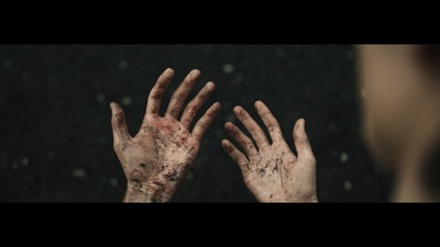 a woman's hands are covered in blood