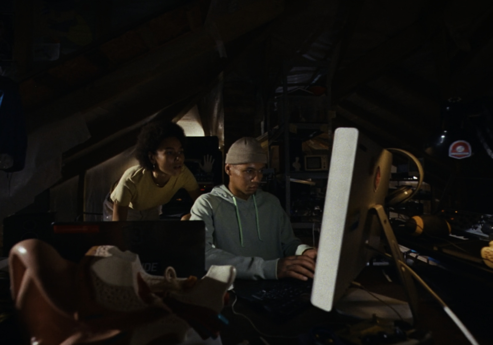 a couple of people sitting at a computer desk