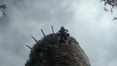 a statue of a man sitting on top of a tower